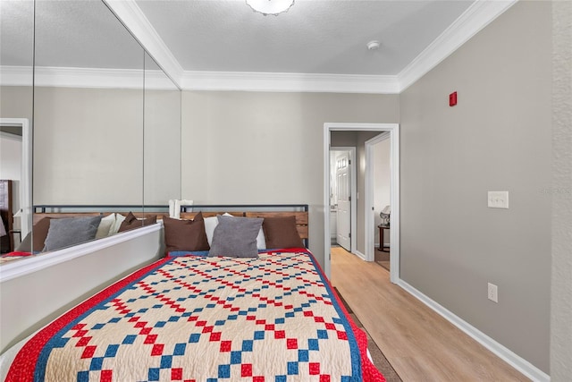 bedroom with ornamental molding, a textured ceiling, and light hardwood / wood-style flooring