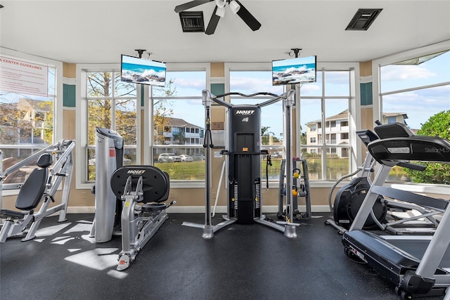 exercise room with ceiling fan and plenty of natural light