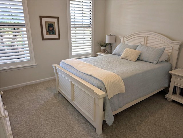 carpeted bedroom featuring multiple windows