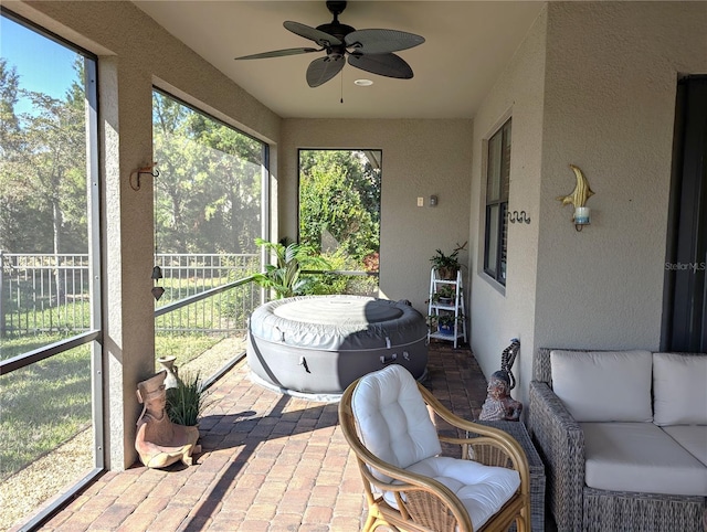 sunroom / solarium featuring ceiling fan