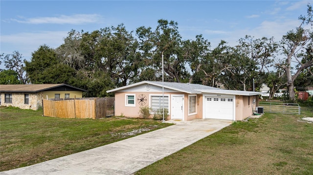 ranch-style house featuring a front yard, a garage, and cooling unit