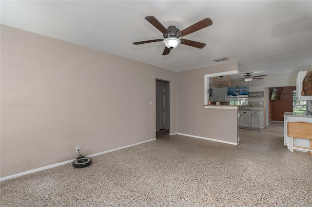 unfurnished living room with ceiling fan