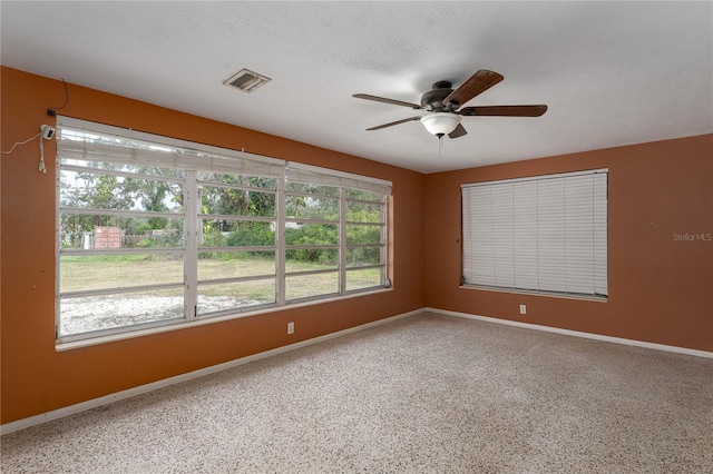 spare room featuring a textured ceiling and ceiling fan