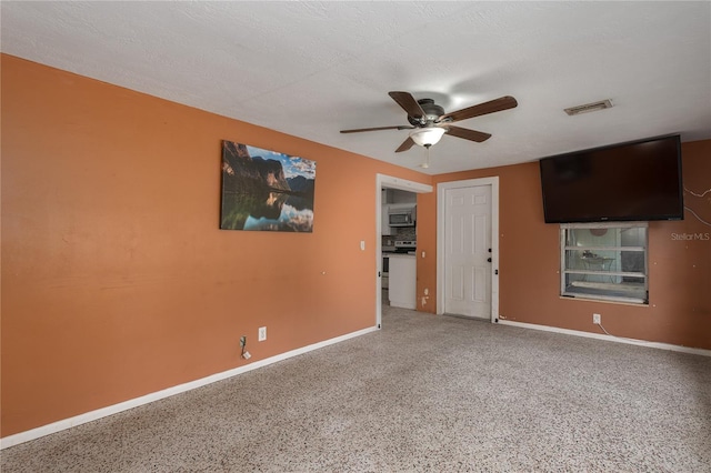 spare room featuring ceiling fan and a textured ceiling