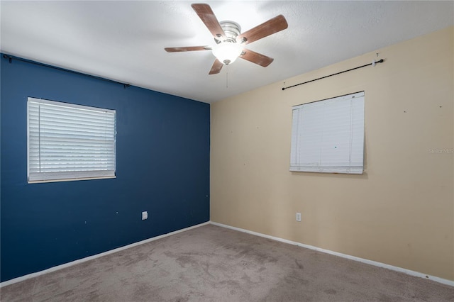 carpeted empty room featuring ceiling fan