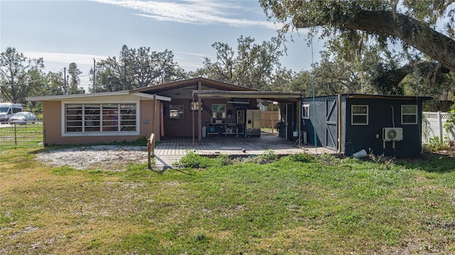 back of property with a lawn