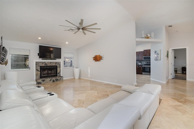 living room featuring built in shelves, ceiling fan, a fireplace, and high vaulted ceiling