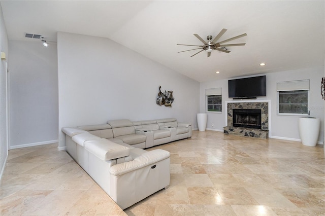 living room with ceiling fan, a fireplace, and lofted ceiling