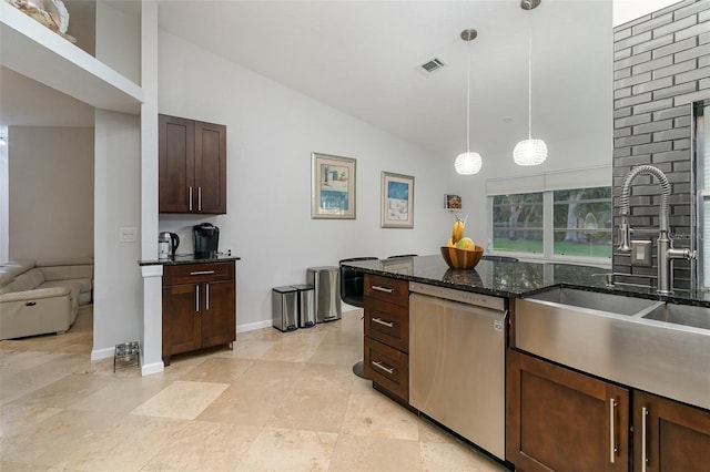 kitchen featuring dark brown cabinetry, hanging light fixtures, stainless steel dishwasher, dark stone counters, and lofted ceiling