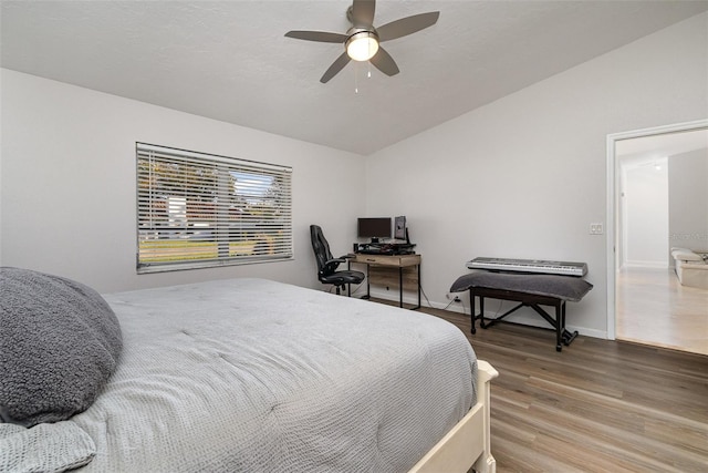 bedroom featuring wood-type flooring, ceiling fan, and lofted ceiling