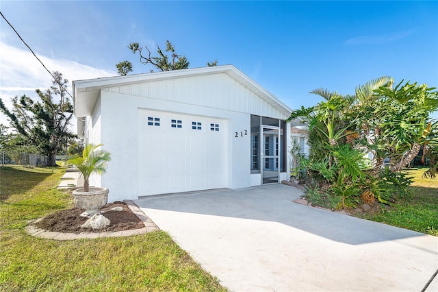 view of front of house featuring a garage and a front lawn