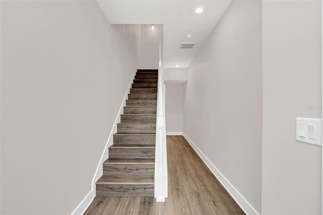 stairs with hardwood / wood-style flooring