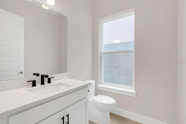 bathroom with toilet, tile patterned flooring, and vanity