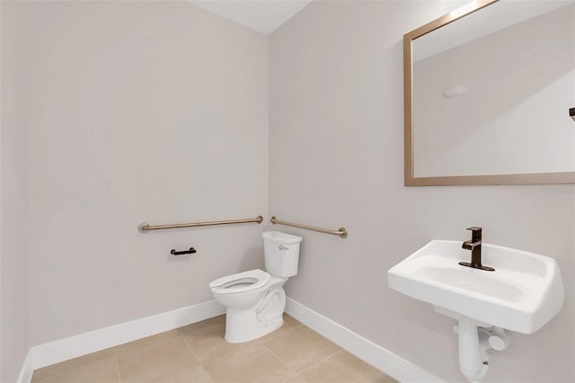 bathroom featuring toilet, tile patterned flooring, and sink