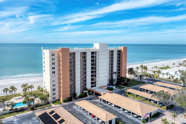 drone / aerial view with a beach view and a water view