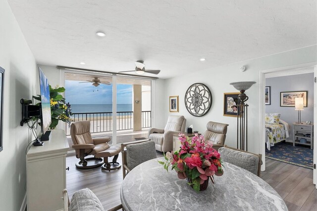 dining area featuring hardwood / wood-style floors and a wall of windows