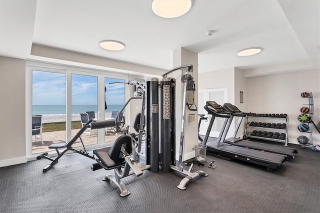 workout area featuring a water view