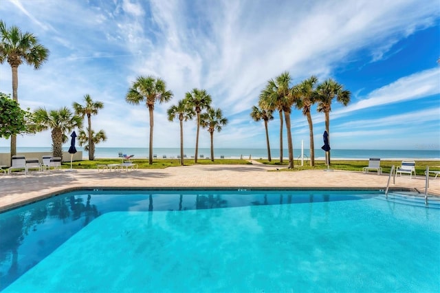 view of pool with a water view