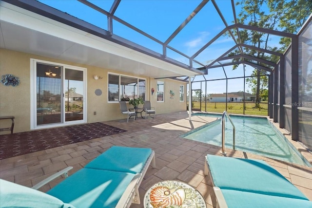 view of swimming pool with glass enclosure and a patio area