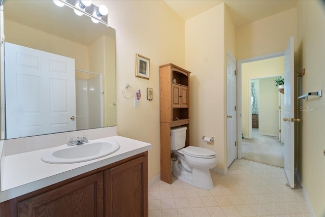 bathroom featuring walk in shower, vanity, and toilet