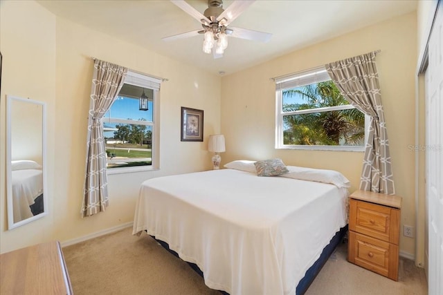 carpeted bedroom featuring ceiling fan