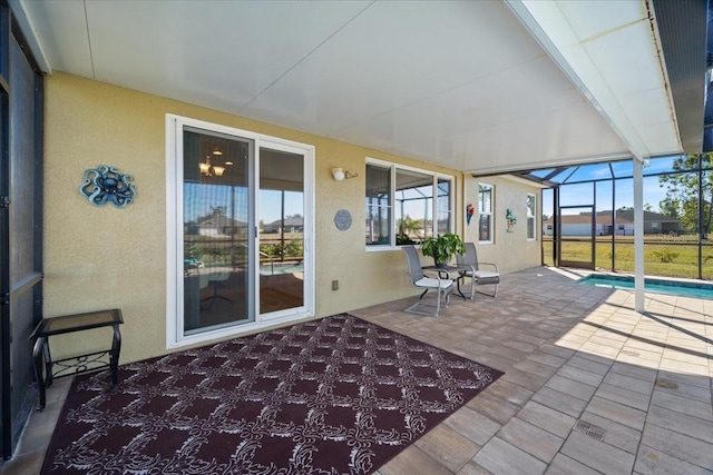 view of patio / terrace featuring a lanai