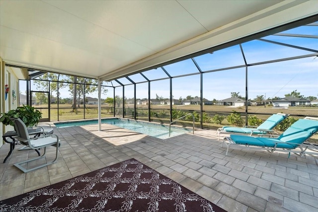 view of swimming pool featuring a patio area and glass enclosure