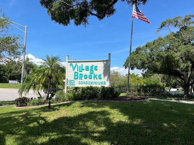 community / neighborhood sign with a lawn