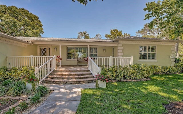 ranch-style home featuring a porch and a front yard