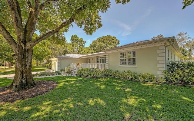 ranch-style house with a front yard and a porch