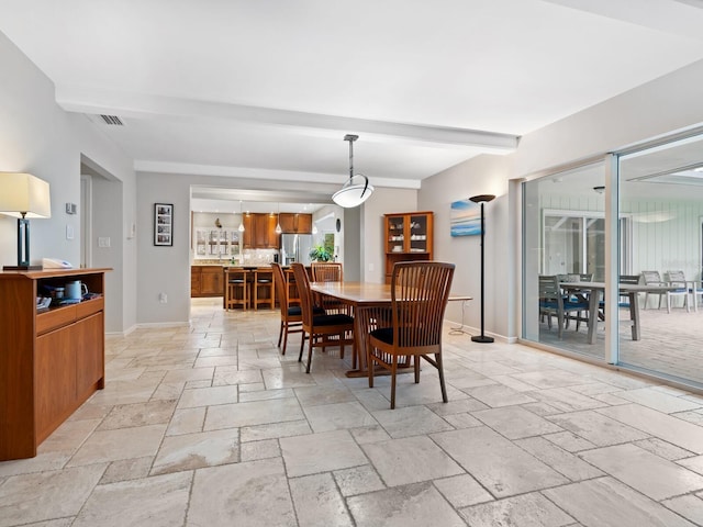 dining room with beam ceiling