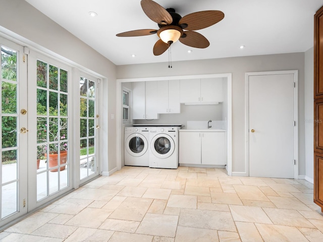 laundry area with ceiling fan, sink, separate washer and dryer, and cabinets