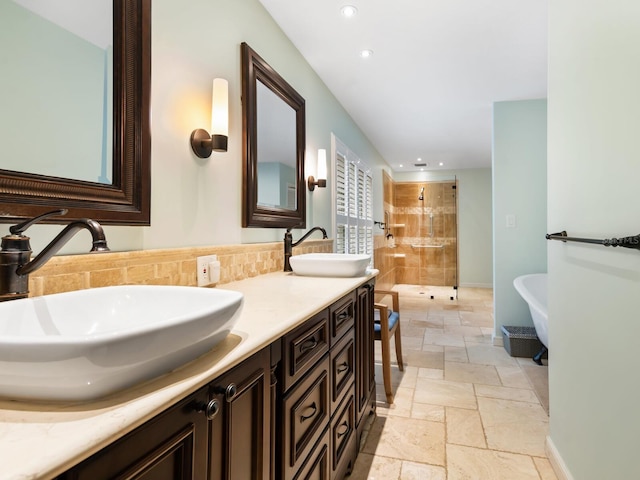 bathroom featuring backsplash, separate shower and tub, and vanity