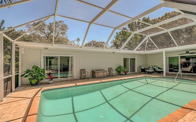 view of swimming pool featuring a lanai, ceiling fan, and a patio