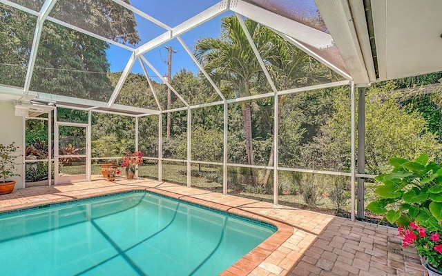 view of swimming pool featuring a lanai and a patio