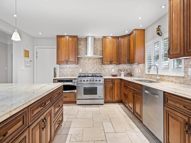 kitchen with decorative backsplash, sink, hanging light fixtures, stainless steel appliances, and wall chimney exhaust hood