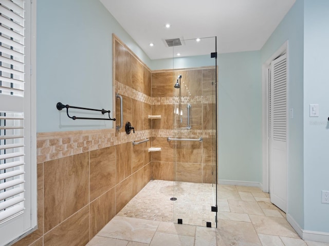 bathroom featuring a shower with door