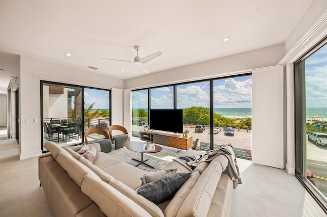 living room with ceiling fan and a healthy amount of sunlight