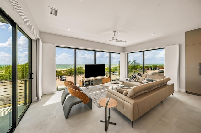 living room with ceiling fan and a wealth of natural light