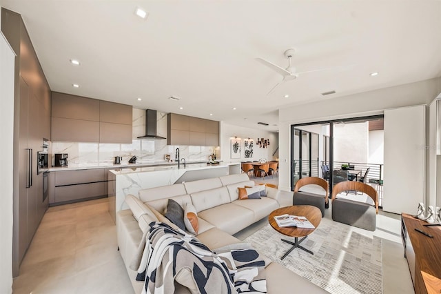 living room with ceiling fan and sink