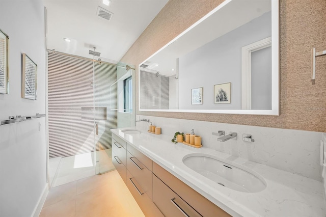 bathroom featuring tile patterned flooring, vanity, and an enclosed shower