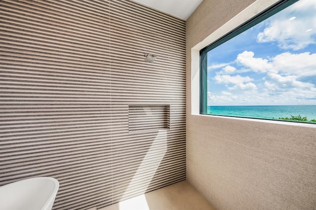 balcony with a water view and a beach view