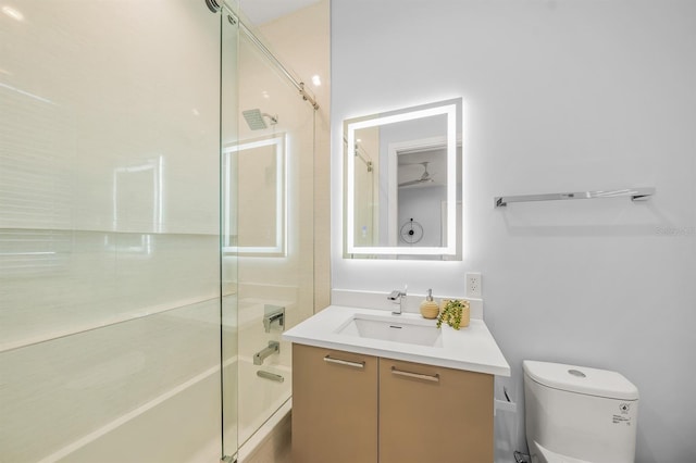 full bathroom with shower / bath combination with glass door, vanity, and toilet