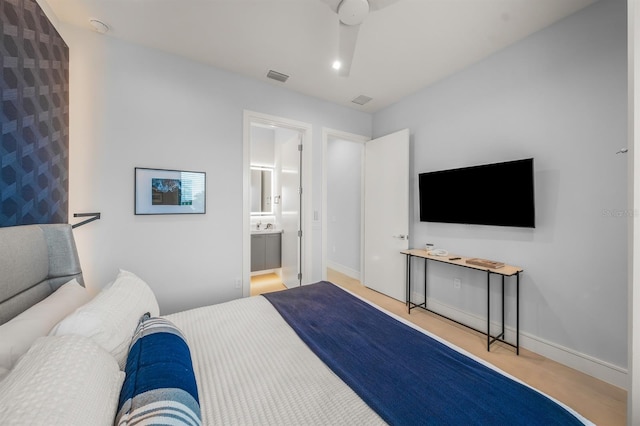 bedroom featuring ensuite bath and ceiling fan