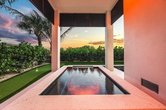 view of pool at dusk