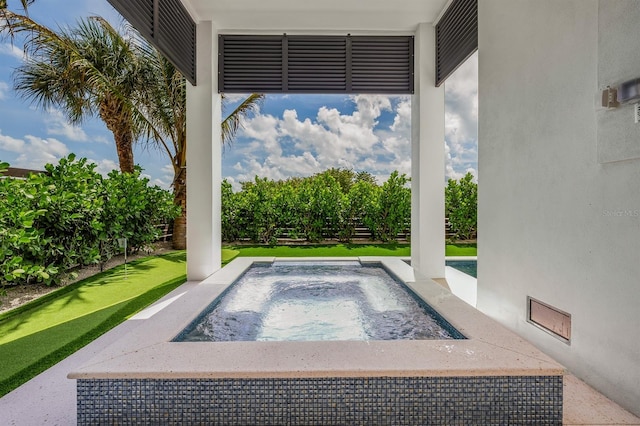 view of swimming pool featuring a hot tub