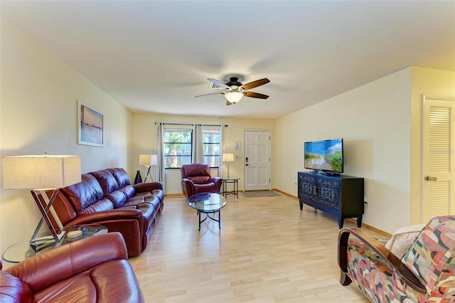 living room featuring light wood-type flooring and ceiling fan