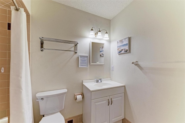 full bathroom with shower / tub combo with curtain, vanity, a textured ceiling, and toilet