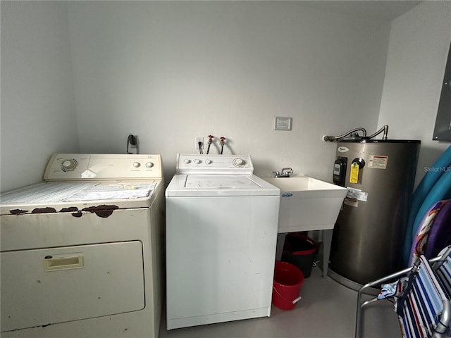 laundry area with sink, washer and clothes dryer, and water heater