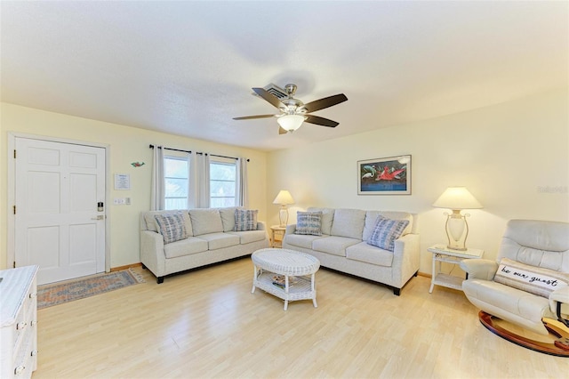 living room featuring ceiling fan and light hardwood / wood-style flooring